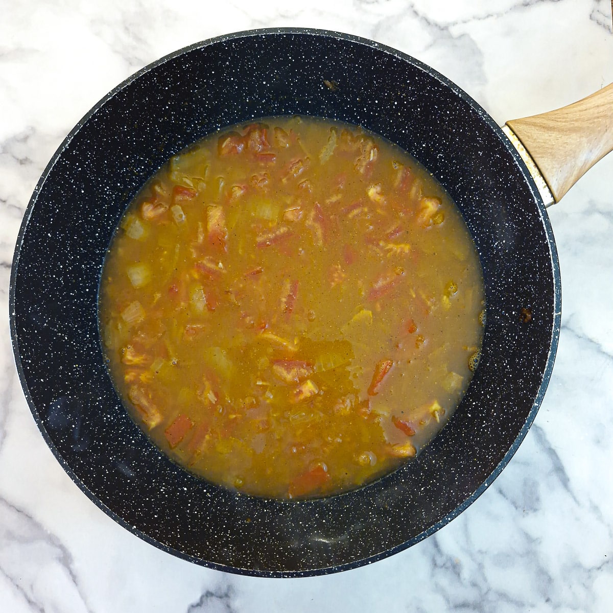 Fish stock stirred into the pilaf.