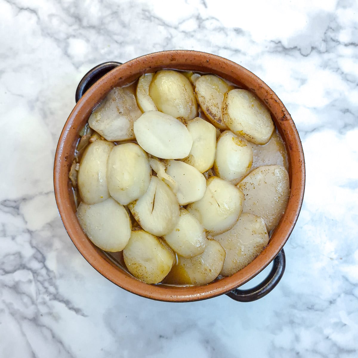 The lamb potjie after it has been in the oven for about 2 hours. The potatoes are very insipid looking and need to be browned.