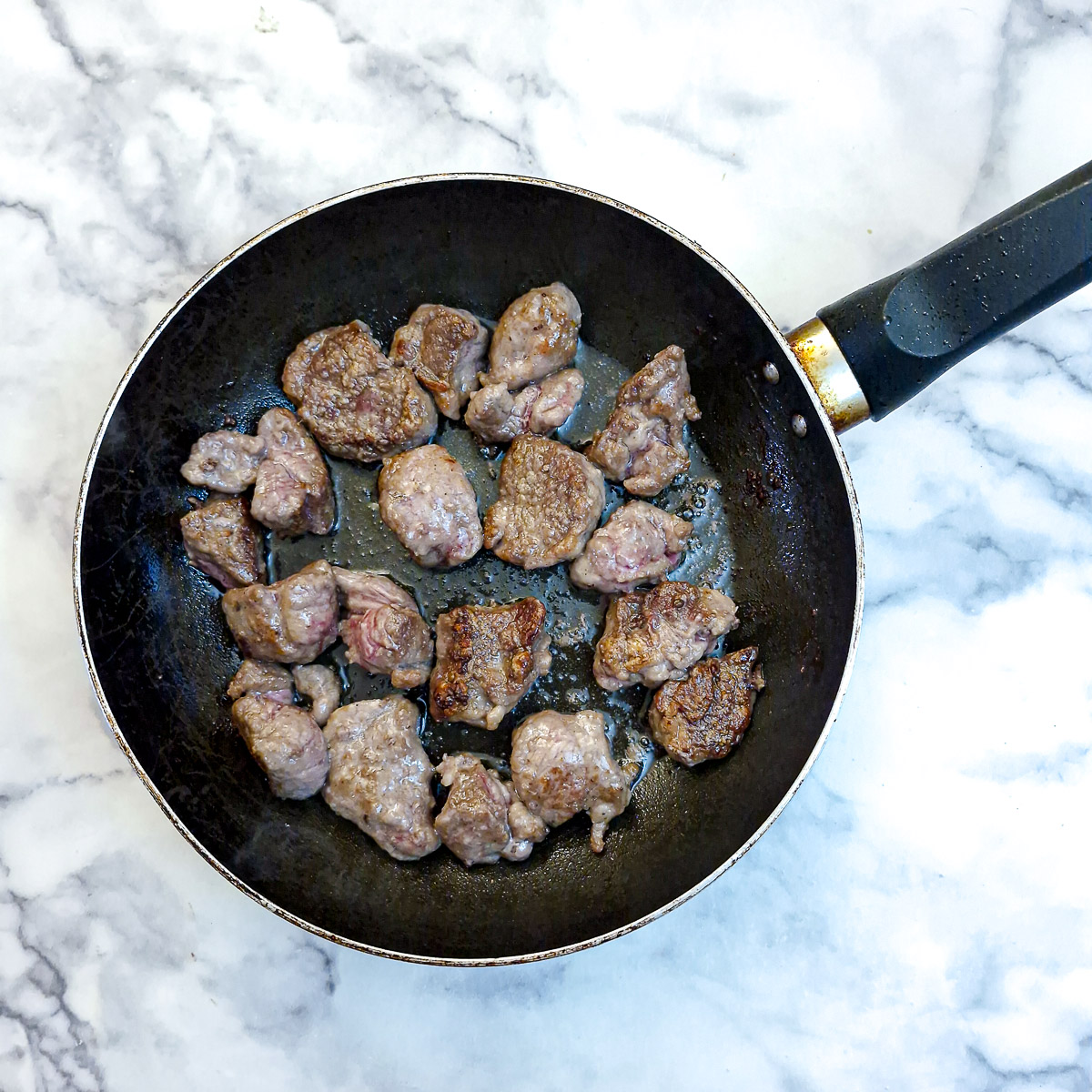 Fully browned lamb ready to be transferred to a casserole dish.
