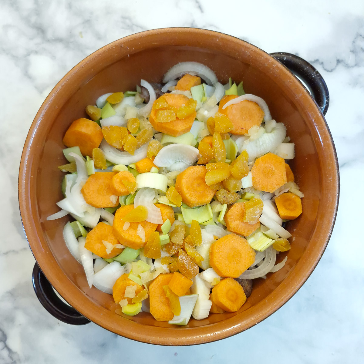 Carrots and chopped apricots layered over the onions.