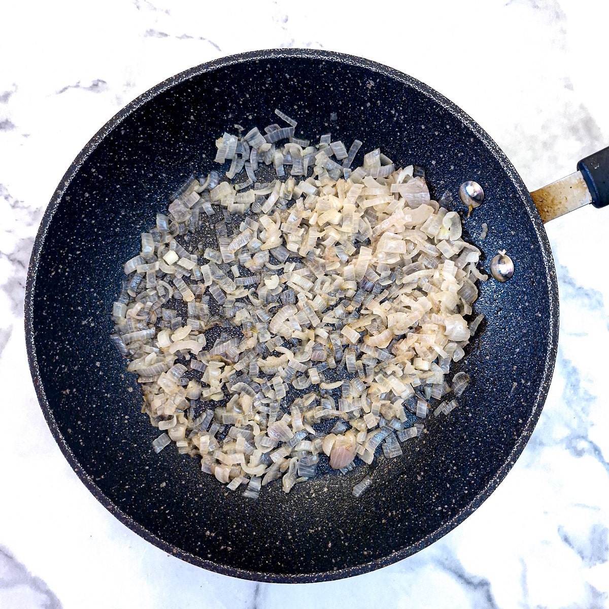 Step 2 - chopped shallots softening in butter in a frying pan,
