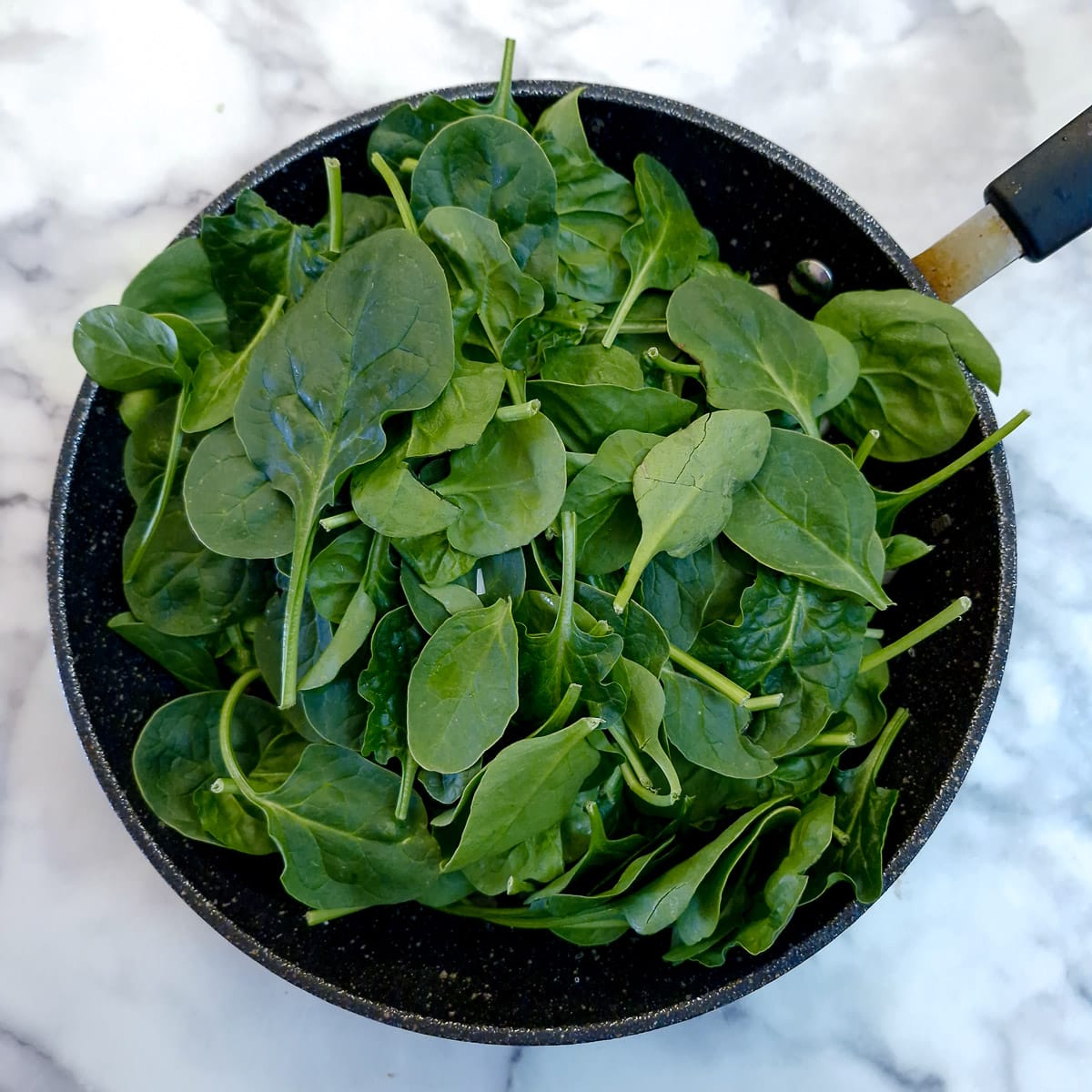 Step 4 - spinach piled into the frying pan.