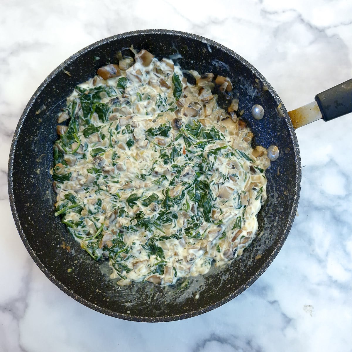 Step 6 - cream cheese stirred into the spinach, mushrooms and onions.