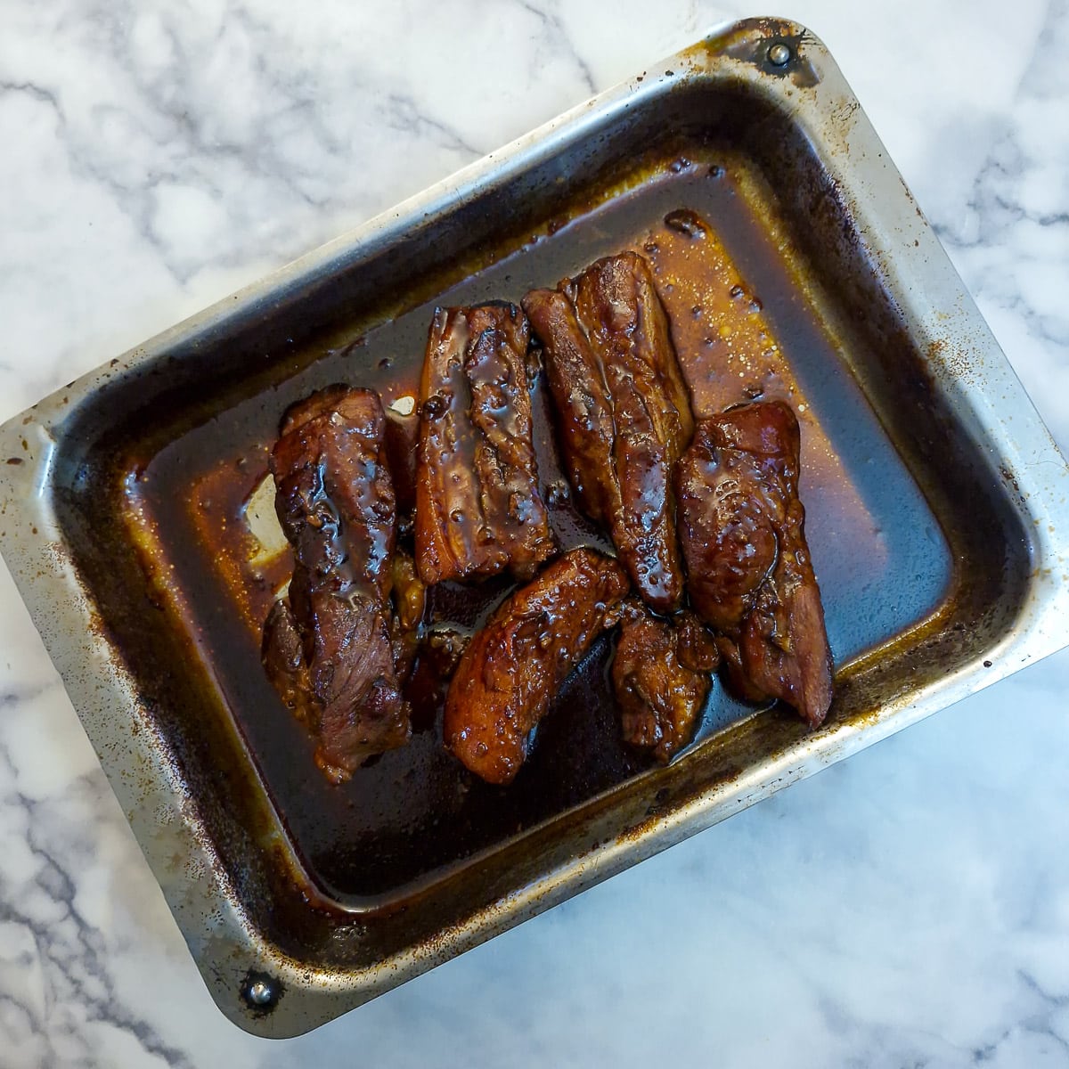 Glazed pork belly slices covered in a sticky thickened glaze.