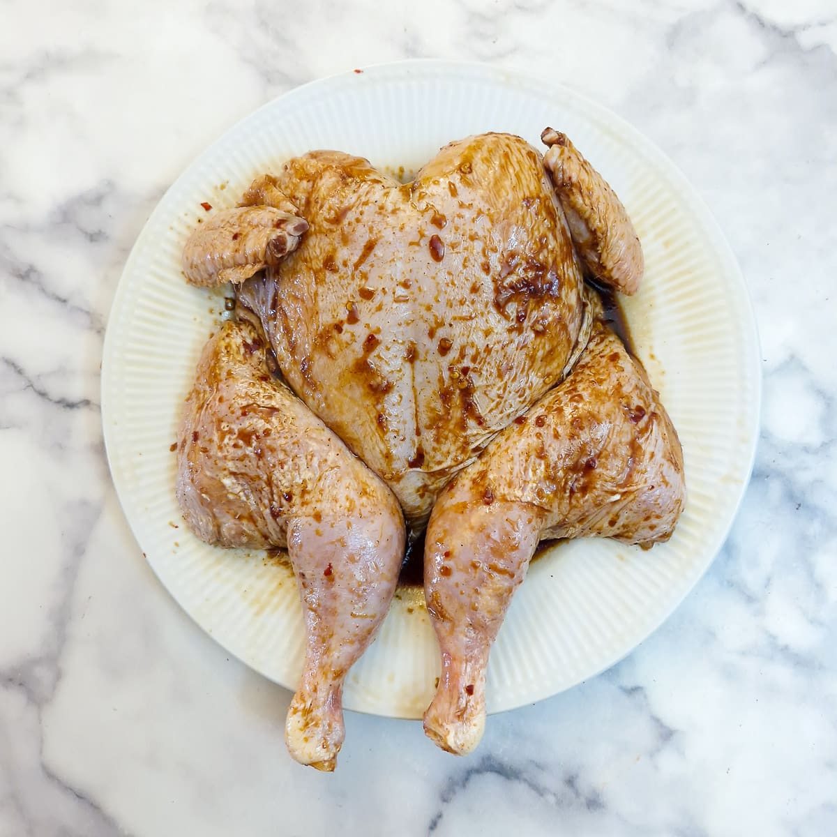 Step 2. A spatchcock chicken rubbed with marinade.