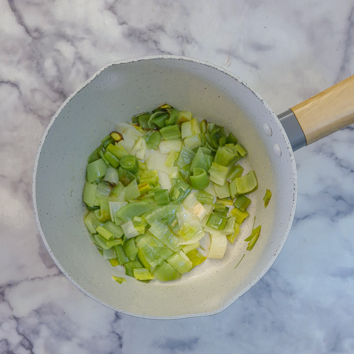Step 2 - chopped leeks softening in butter in a saucepan.