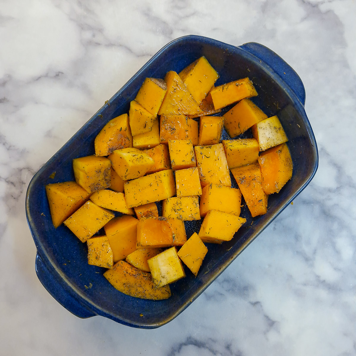 Butternut chunks coated in oil, thyme, salt and pepper.
