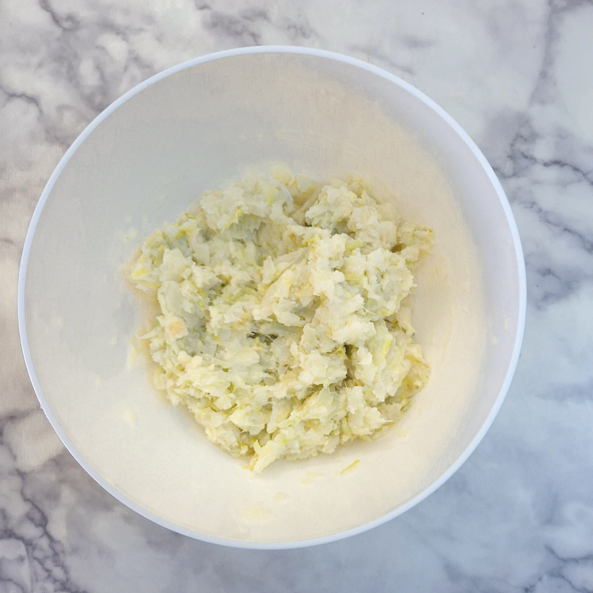 Step 4 - the leeks, cabbage and potatoes mashed with grated cheese in a mixing bowl.