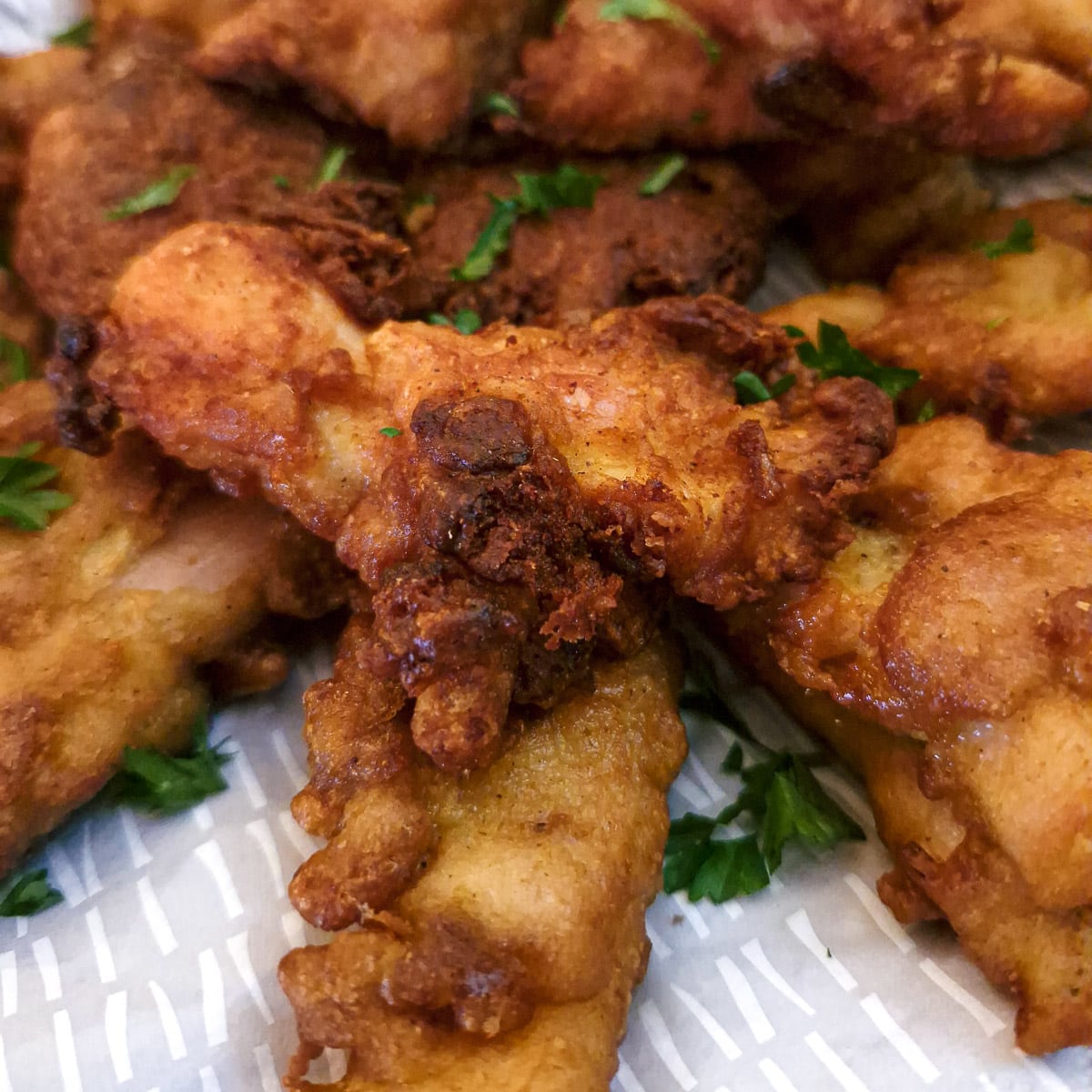 Close up of the crispy curried chicken bites showing the onions in the batter.