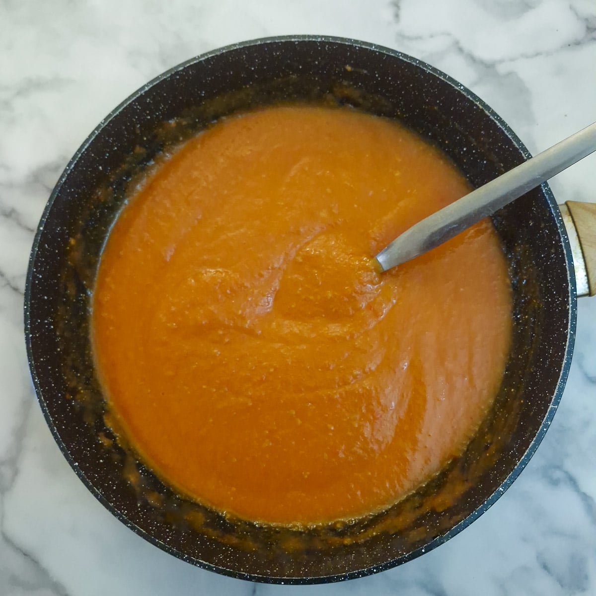 Step 10 - a wok of blended tomato cooking sauce. The consistency looks quite thick.