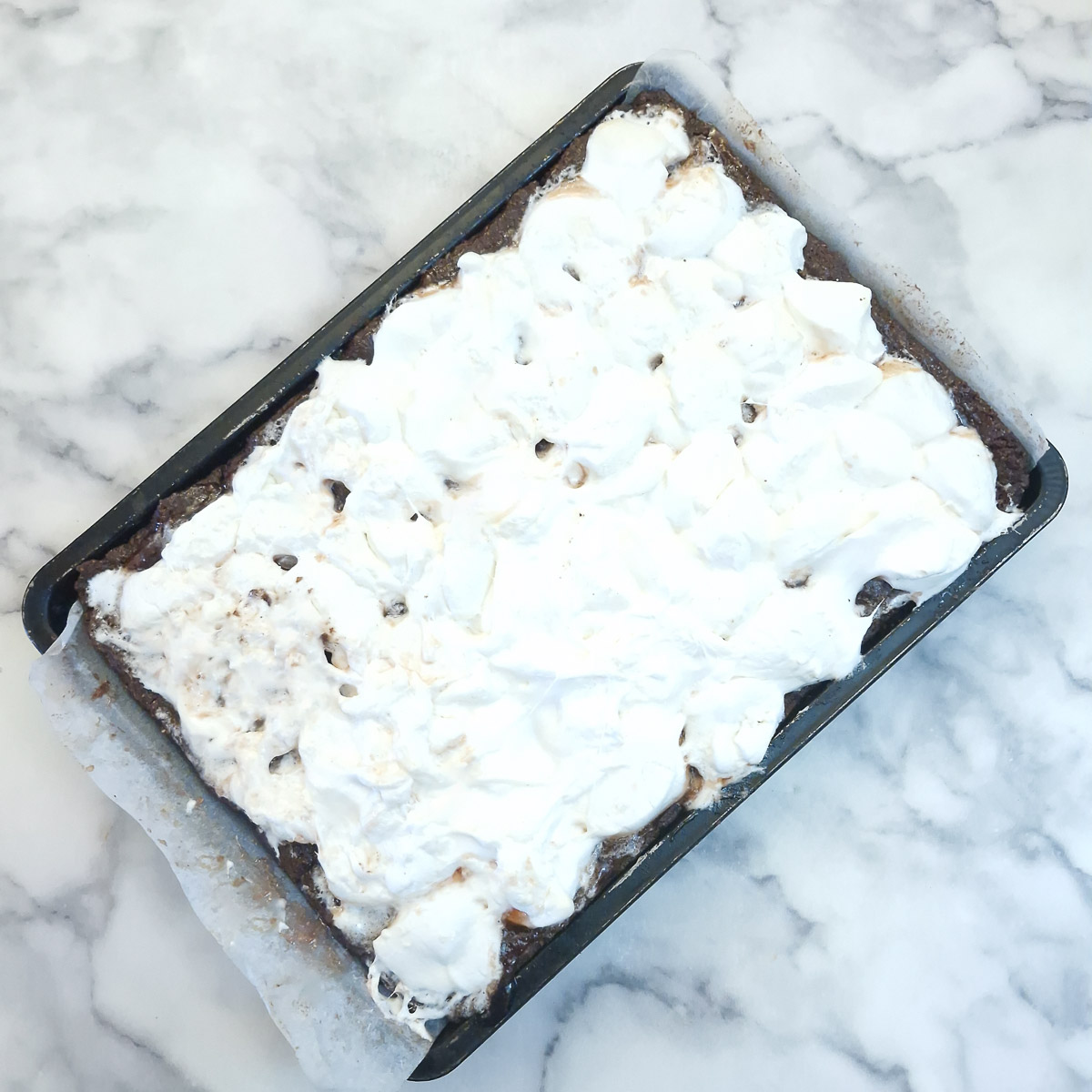 The baking tray with the layer of melted marshmallows.