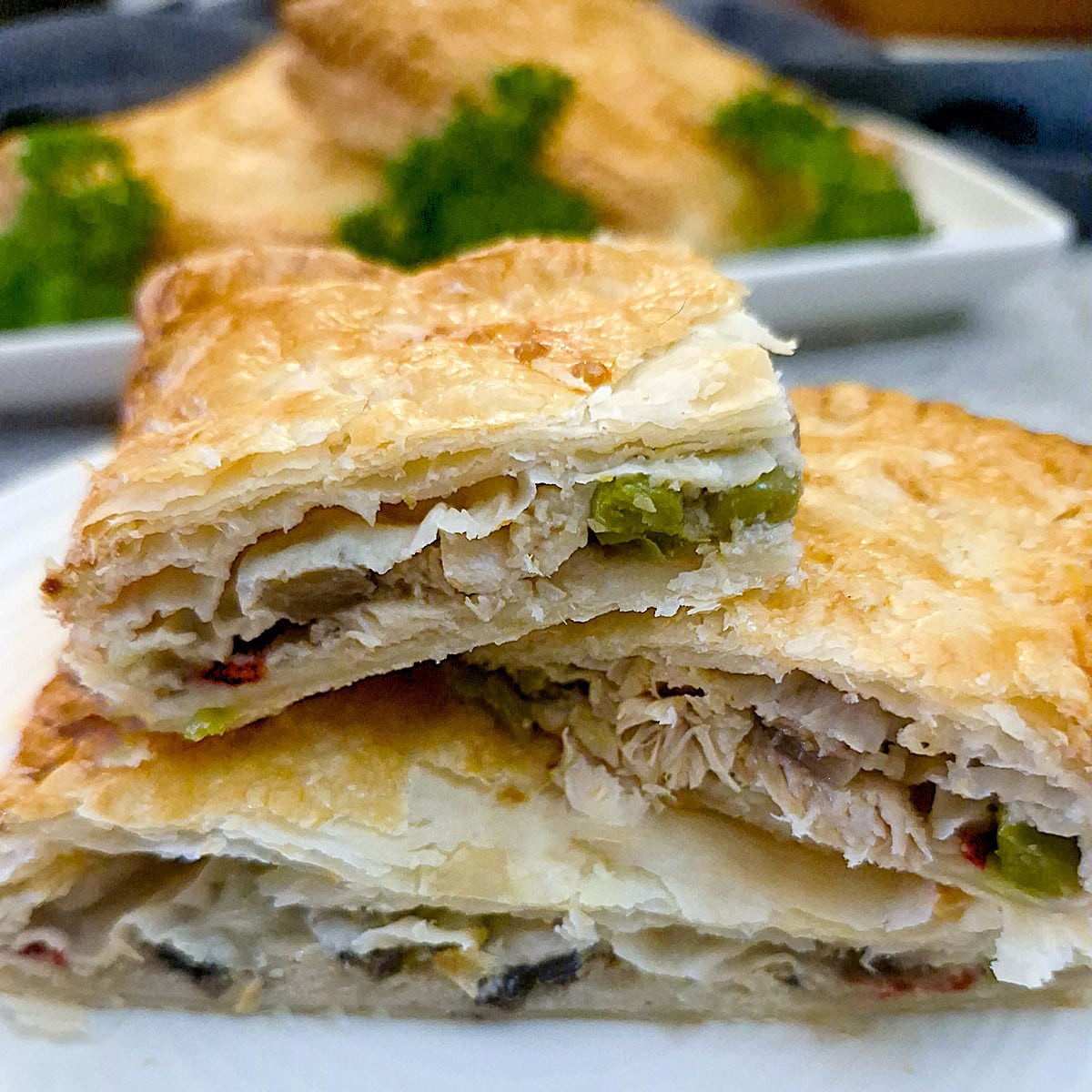 Slices of chicken a la king pies in puff pastry on a plate.
