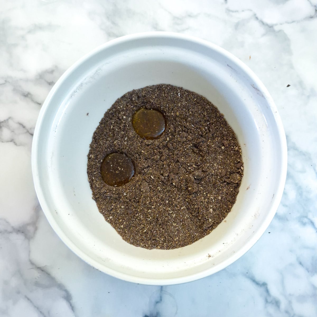 2 indentations made into the dry ingredients to hold 2 tablespoons of syrup.