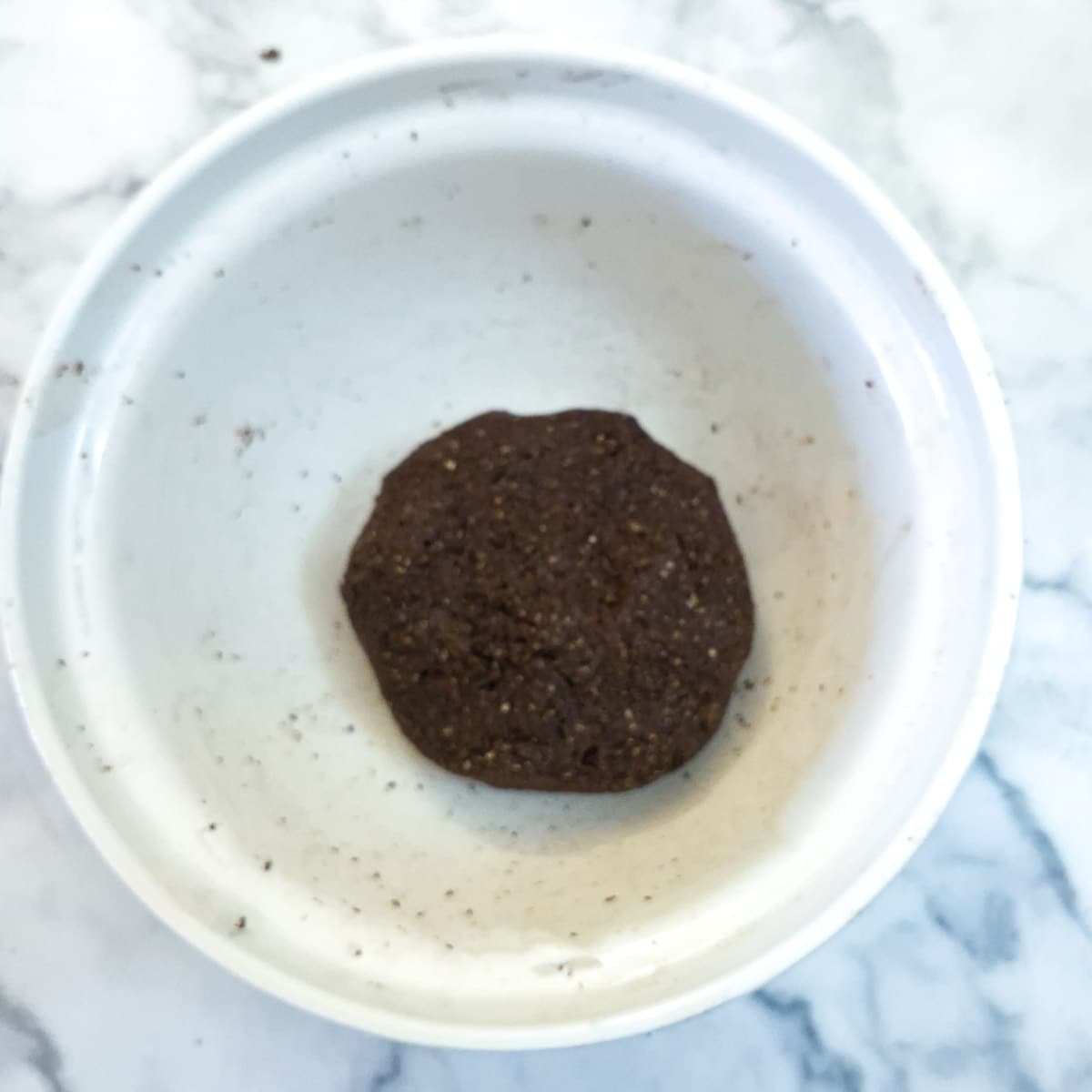 A ball of dough in a mixing bowl.