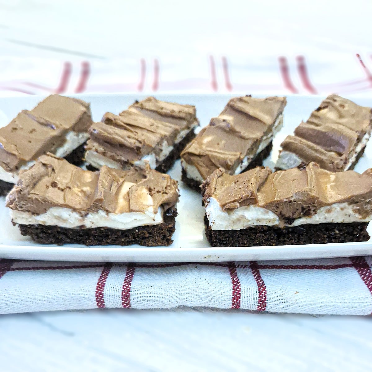 Slices of homemade wagon wheel traybake on a white plate.