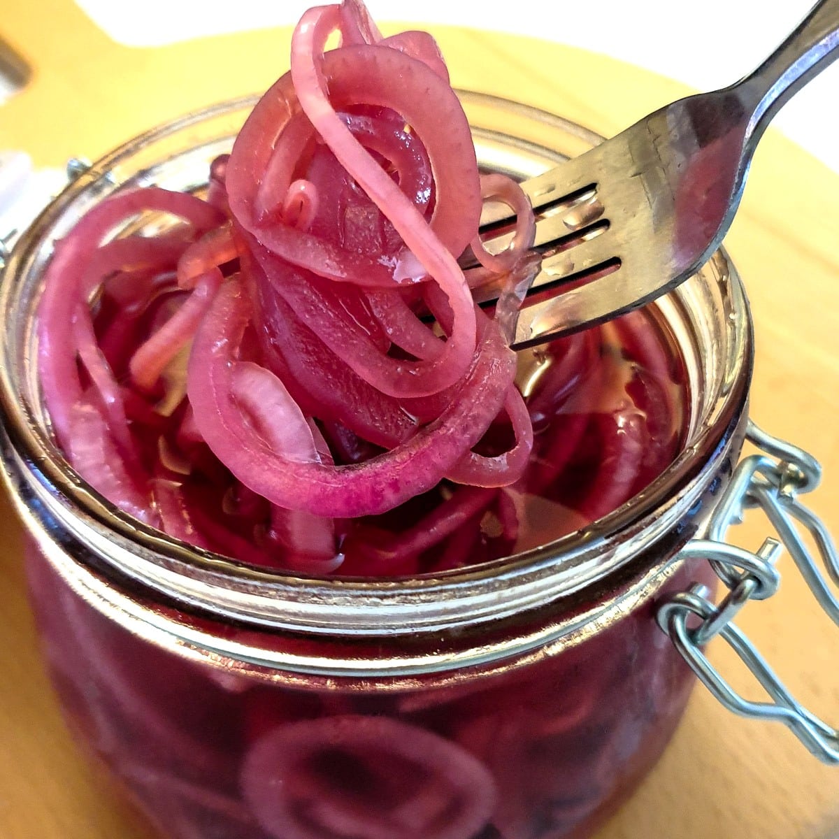 A jar of homemade picked red onions.