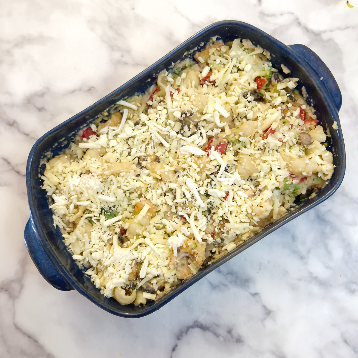 Step 10 - the assembled chicken and pasta bake sprinkled with grated cheese and ready to go in the oven.
