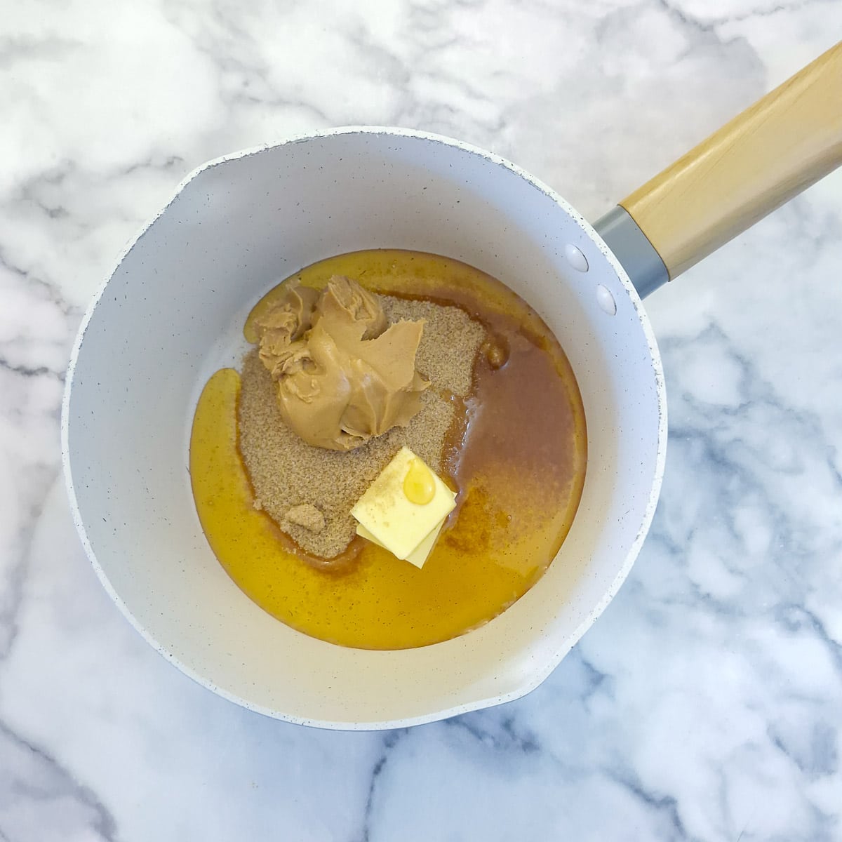 Step 2 - golden syrup, sugar, peanut butter and butter being melted in a saucepan.