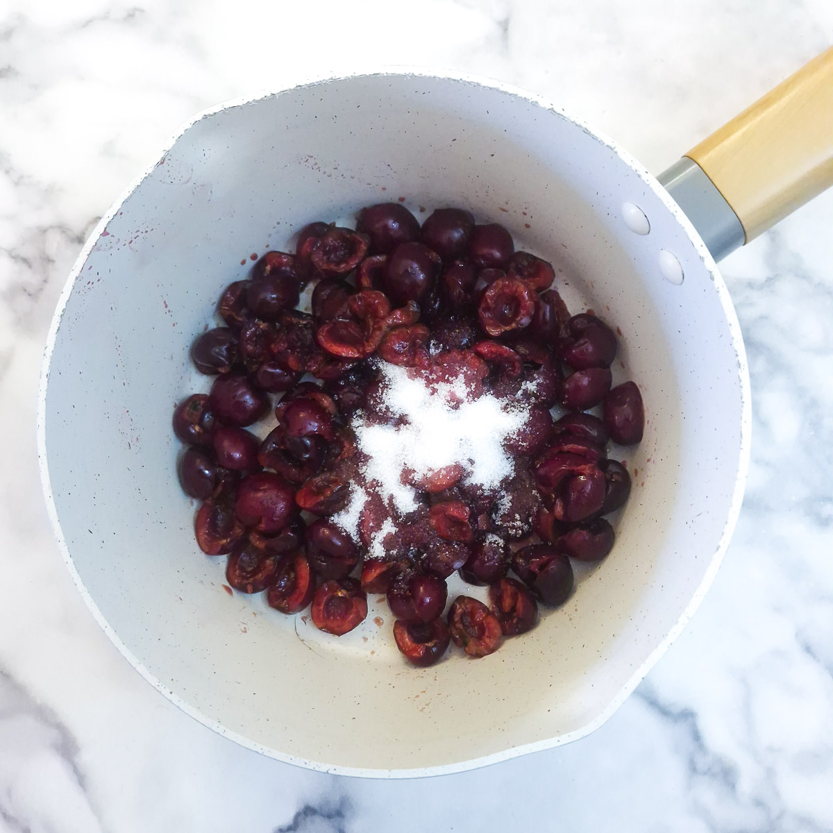 Step 2 - pitted cherries and a little sugar in a saucepan.
