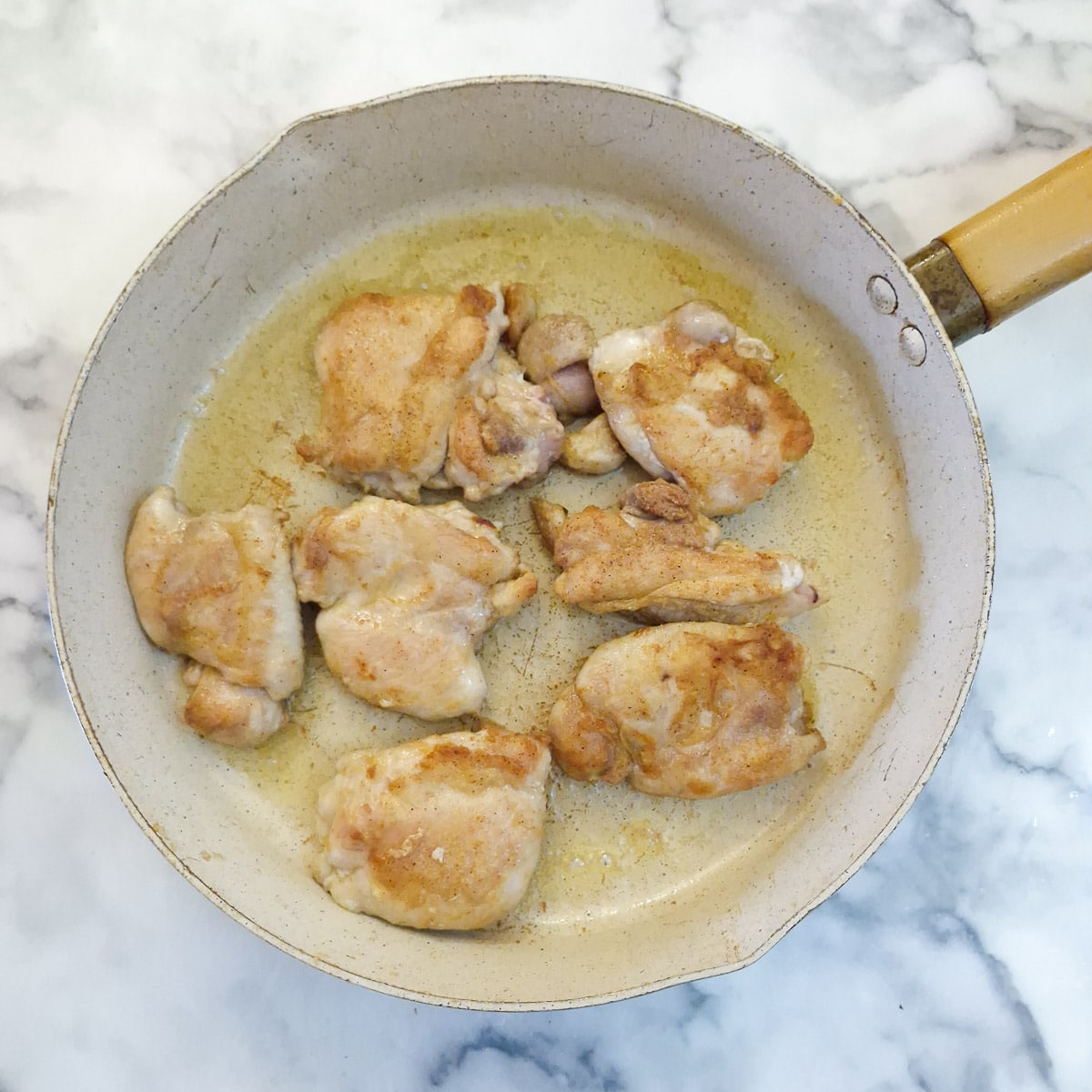 Step 2 - browned chicken thighs in a frying pan.