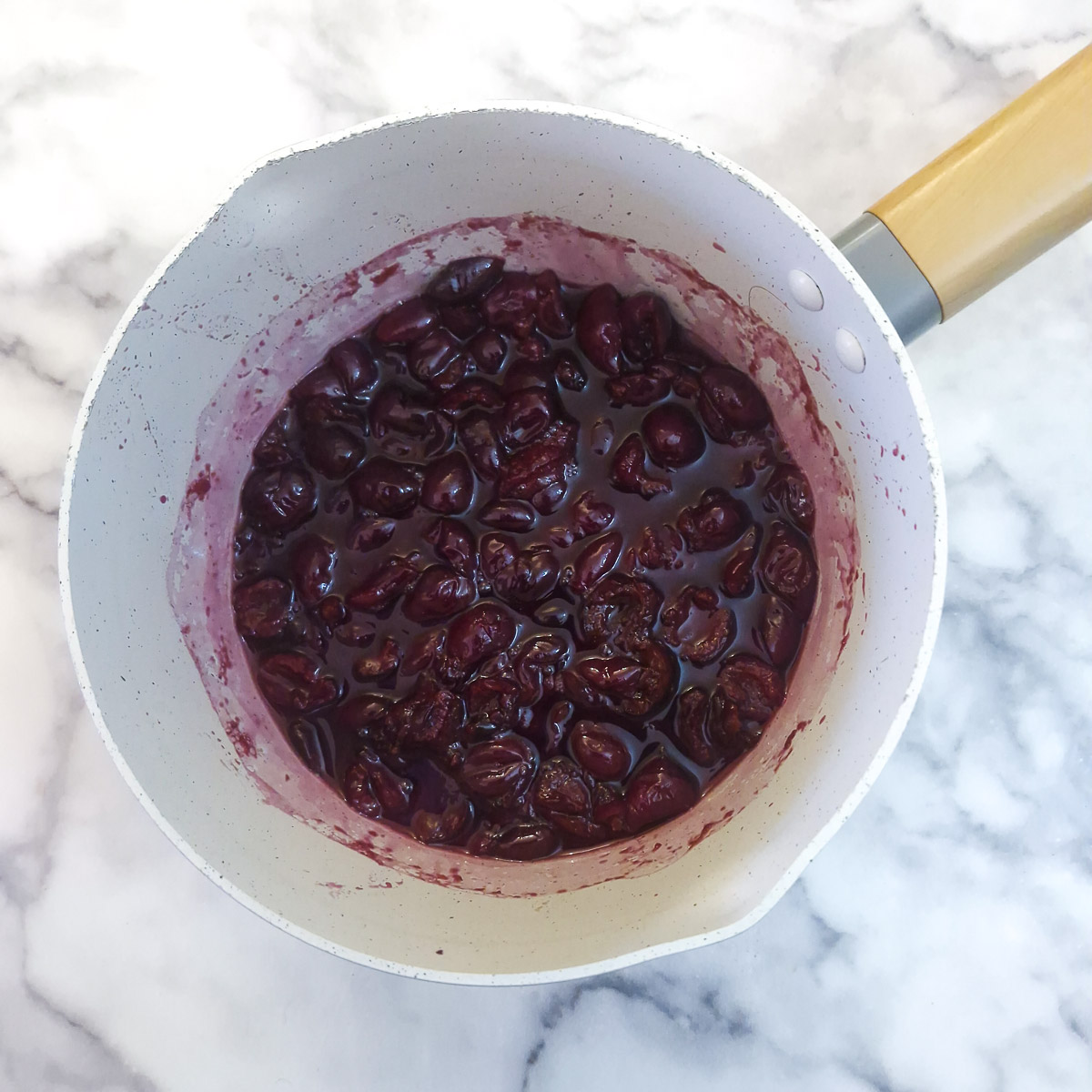 Step 3 - cherries in a saucepan having been simmered for 5 minutes to soften them.