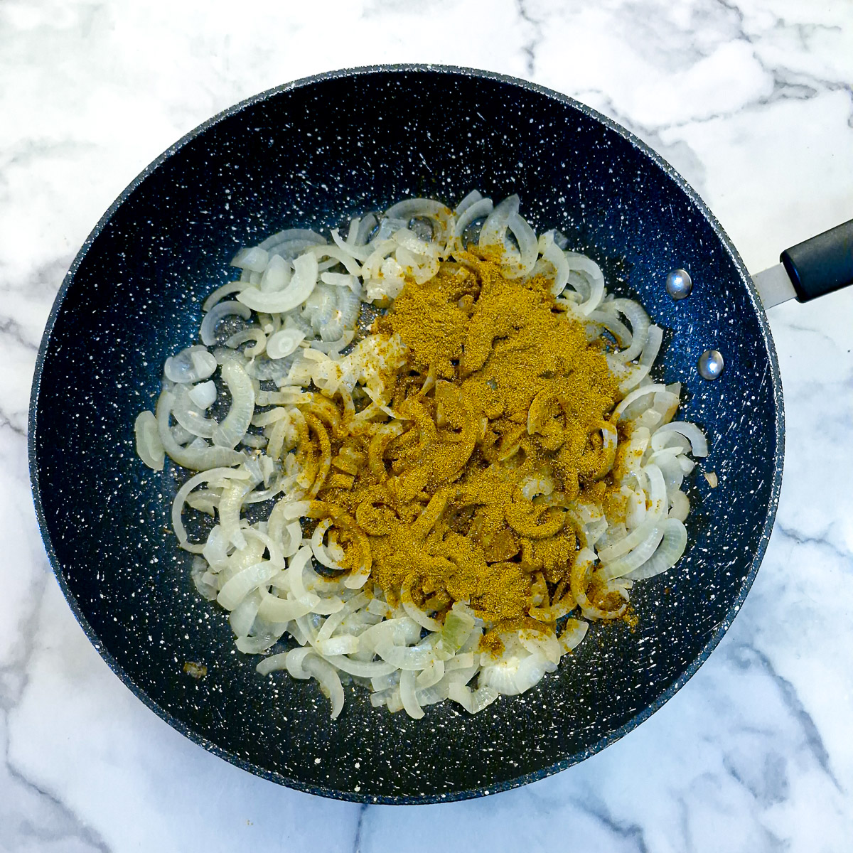Step 3 - curry powder added to the onions.