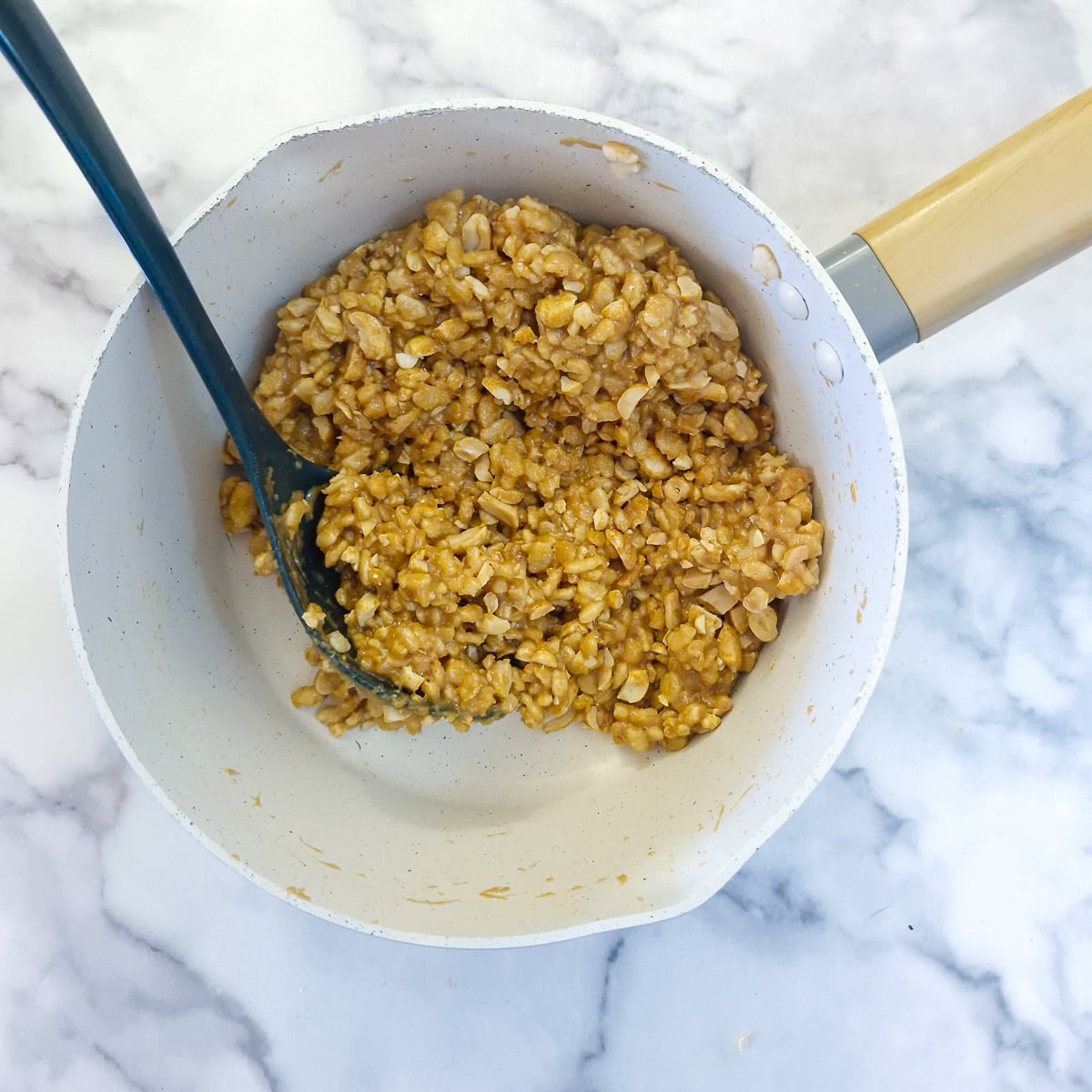 Step 4 - puffed rice cereal and chopped peanuts combined with the peanut butter mixture.
