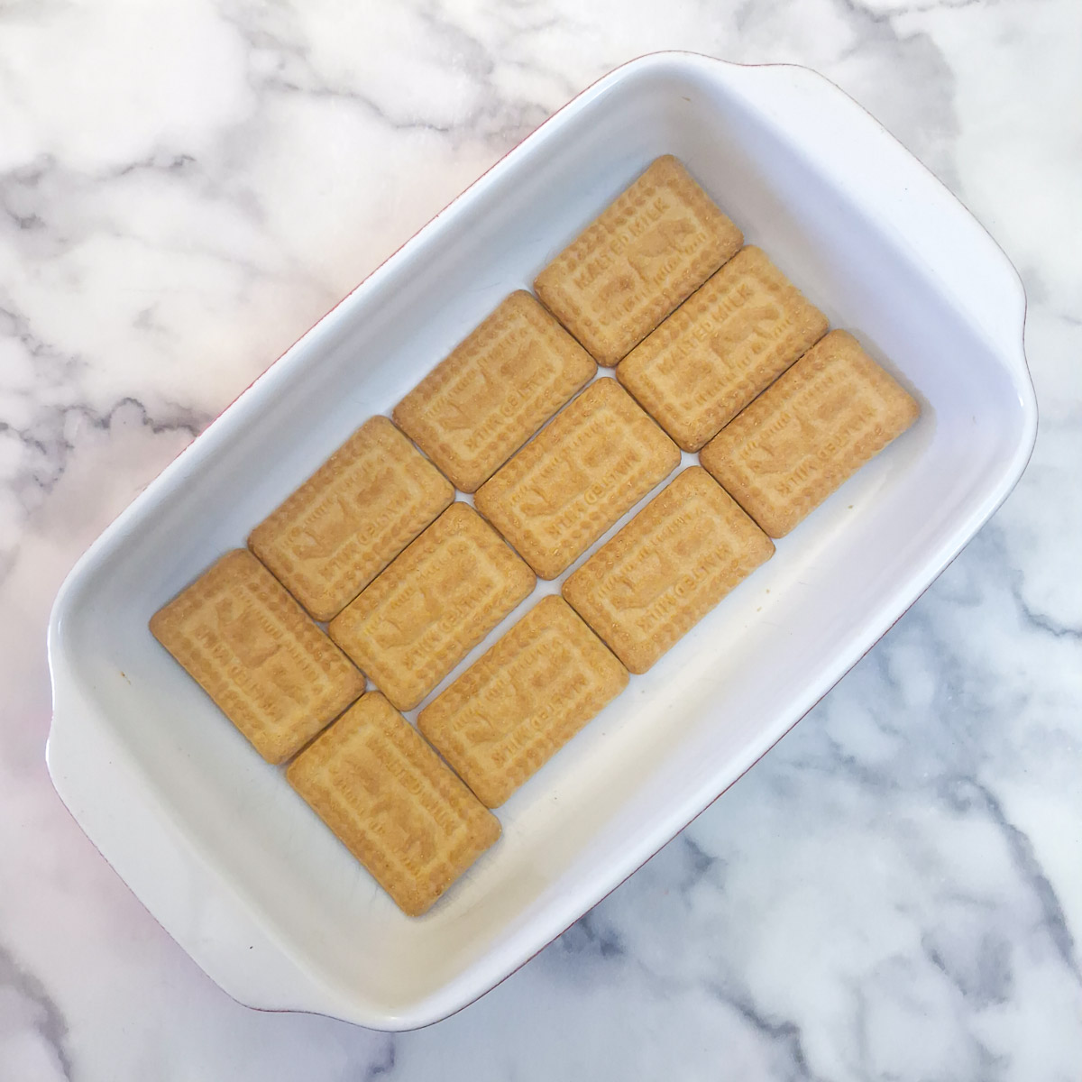 Step 7 - a layer of biscuits in a serving dish.