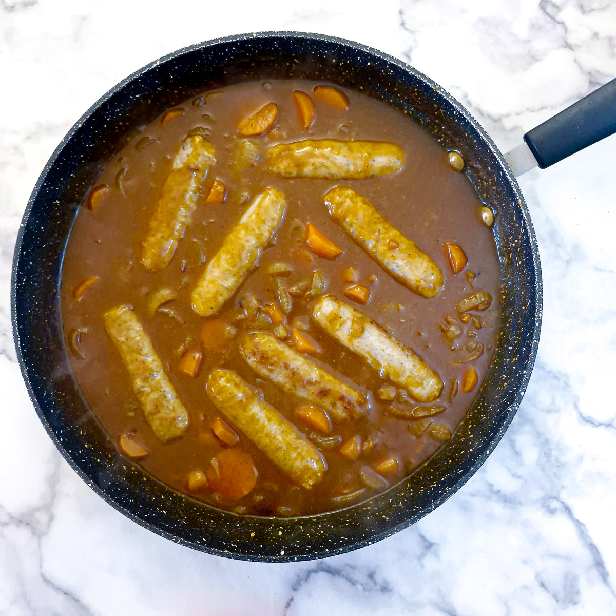 Step 7 - sausages added back to the pan.