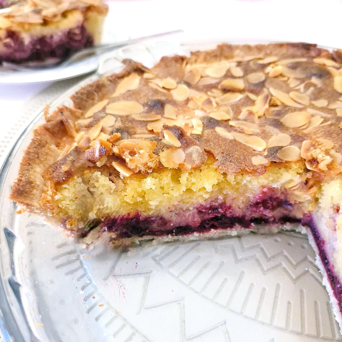 A cross section of the frangipane tart showing the layers of compote, blackberries and frangipane.
