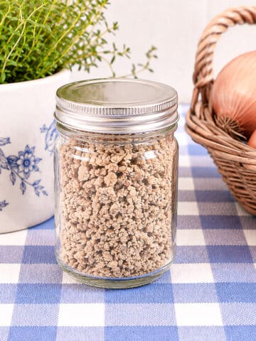 A small screw-top jar filled with homemade French onion seasoning mix.