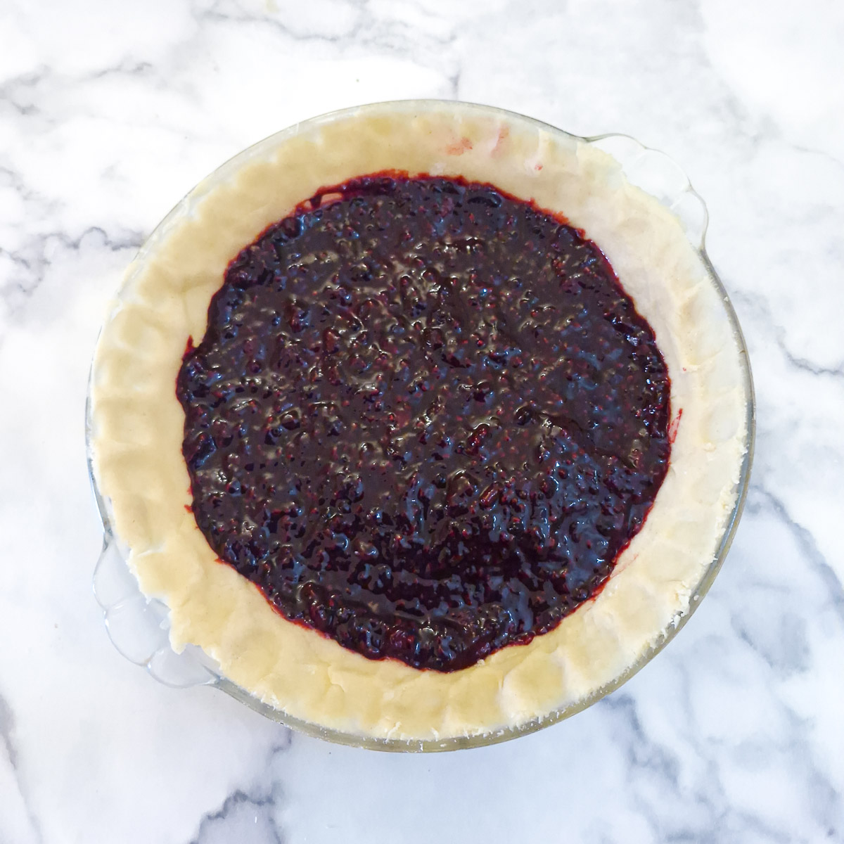 Step 13 - blackberry compote spread onto the pastry in the dish.
