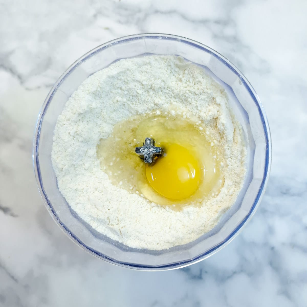 Step 1 - shortcrust pastry being mixed in a food processory.