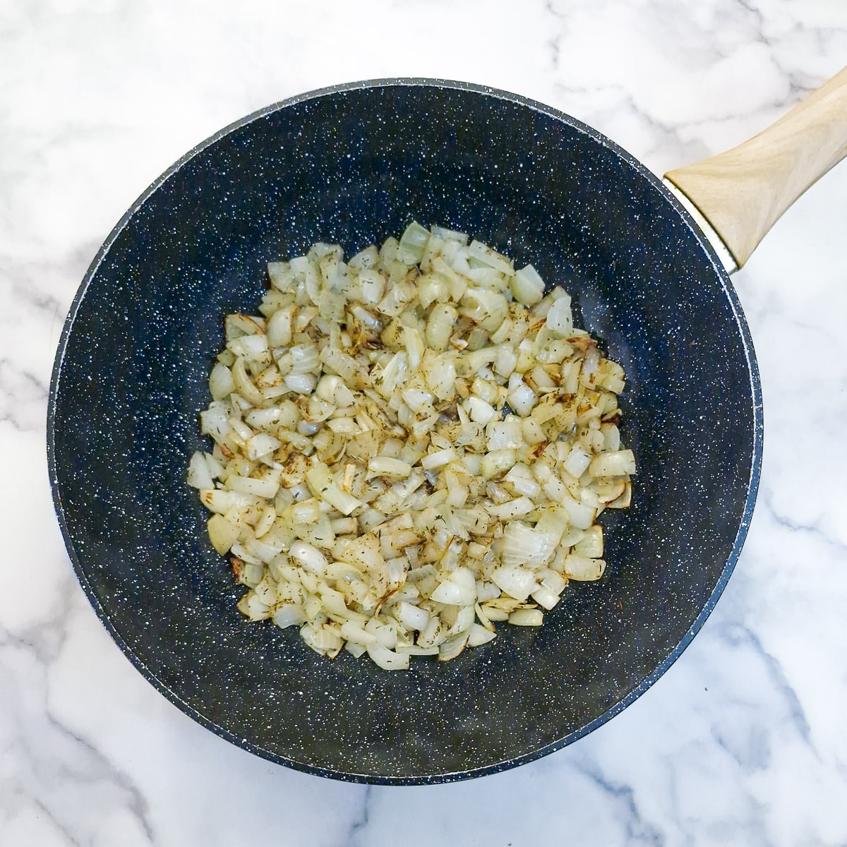 Step 1 - onions softening in a large black wok.
