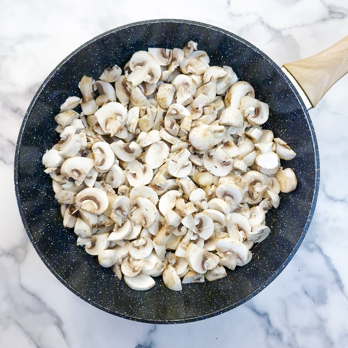 Step 2 - Lots of mushrooms added to the the onions - they've almost filled the pan!