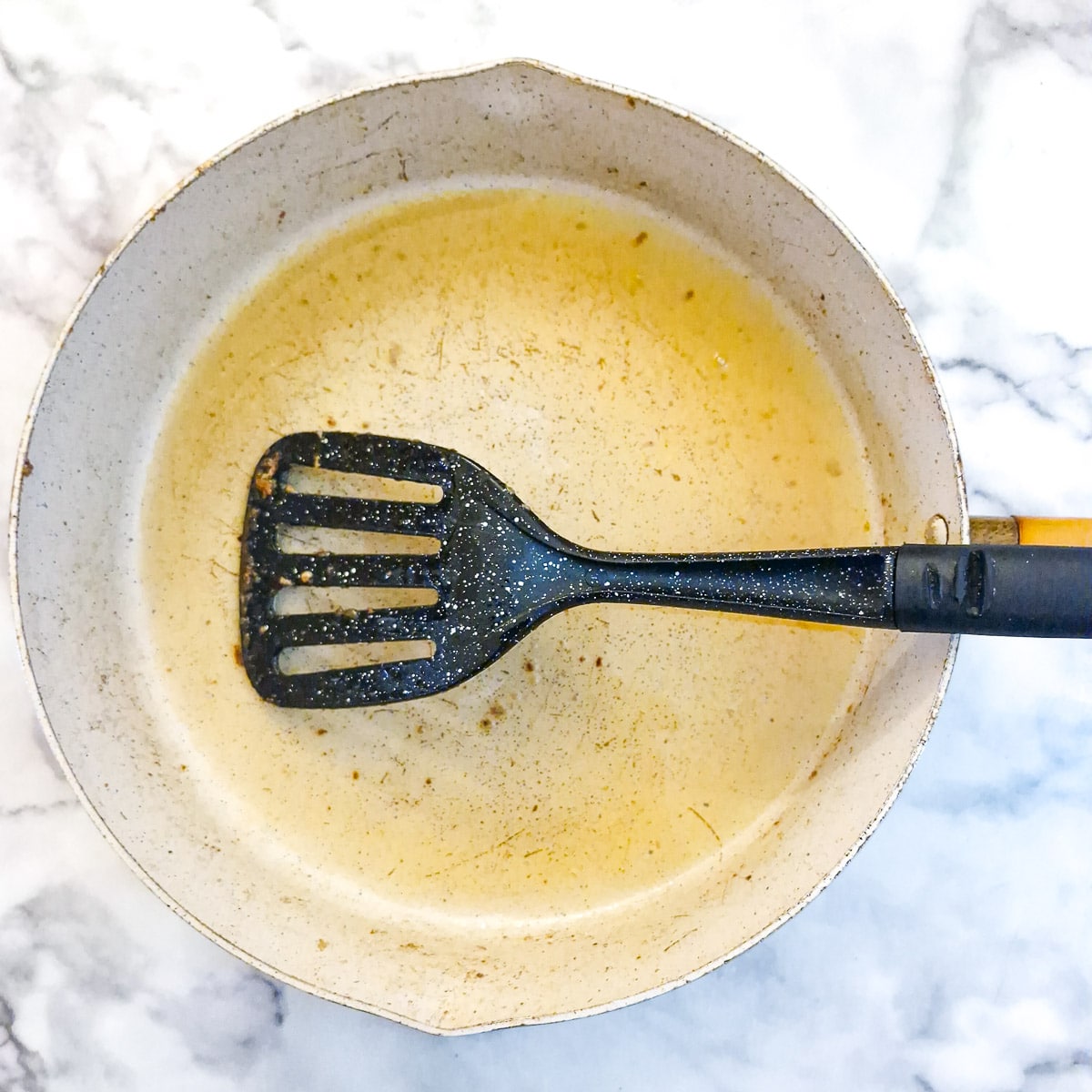 Step 3 - A frying pan being deglazed with white wine.
