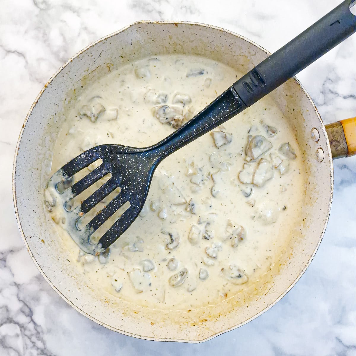 Step 4 - creamy mushroom sauce being combined with mustard.
