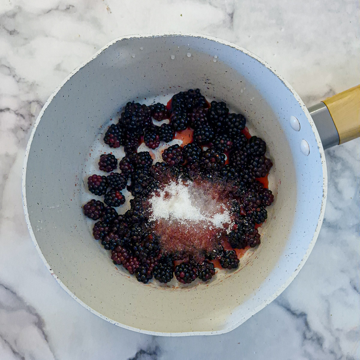 Step 5 - Blackberries with sugar and lemon juice in a saucepan.