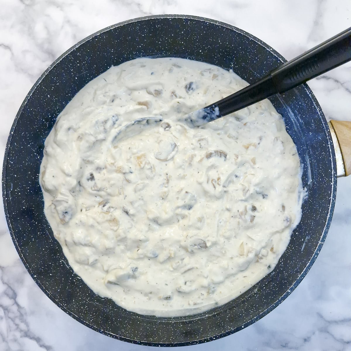 Step 6 - the sauce has simmered in the wok until it is thick and creamy.