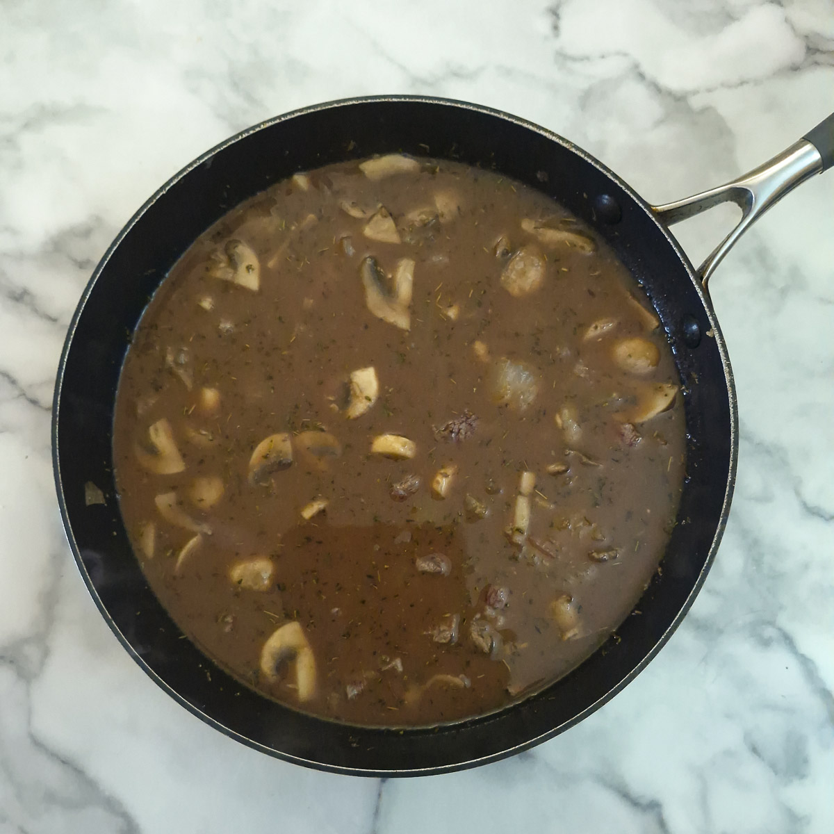 Step 5 - flour, stock and the remaining ingredients stirred into the stew.