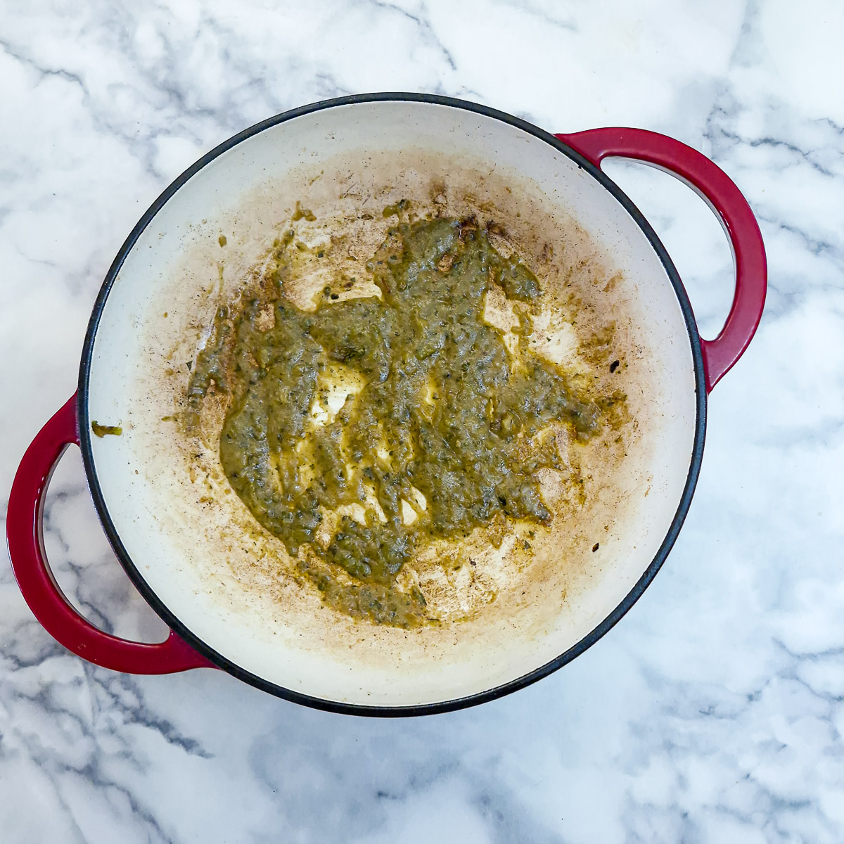 Step 3 - Thai green curry paste frying off in a pan.