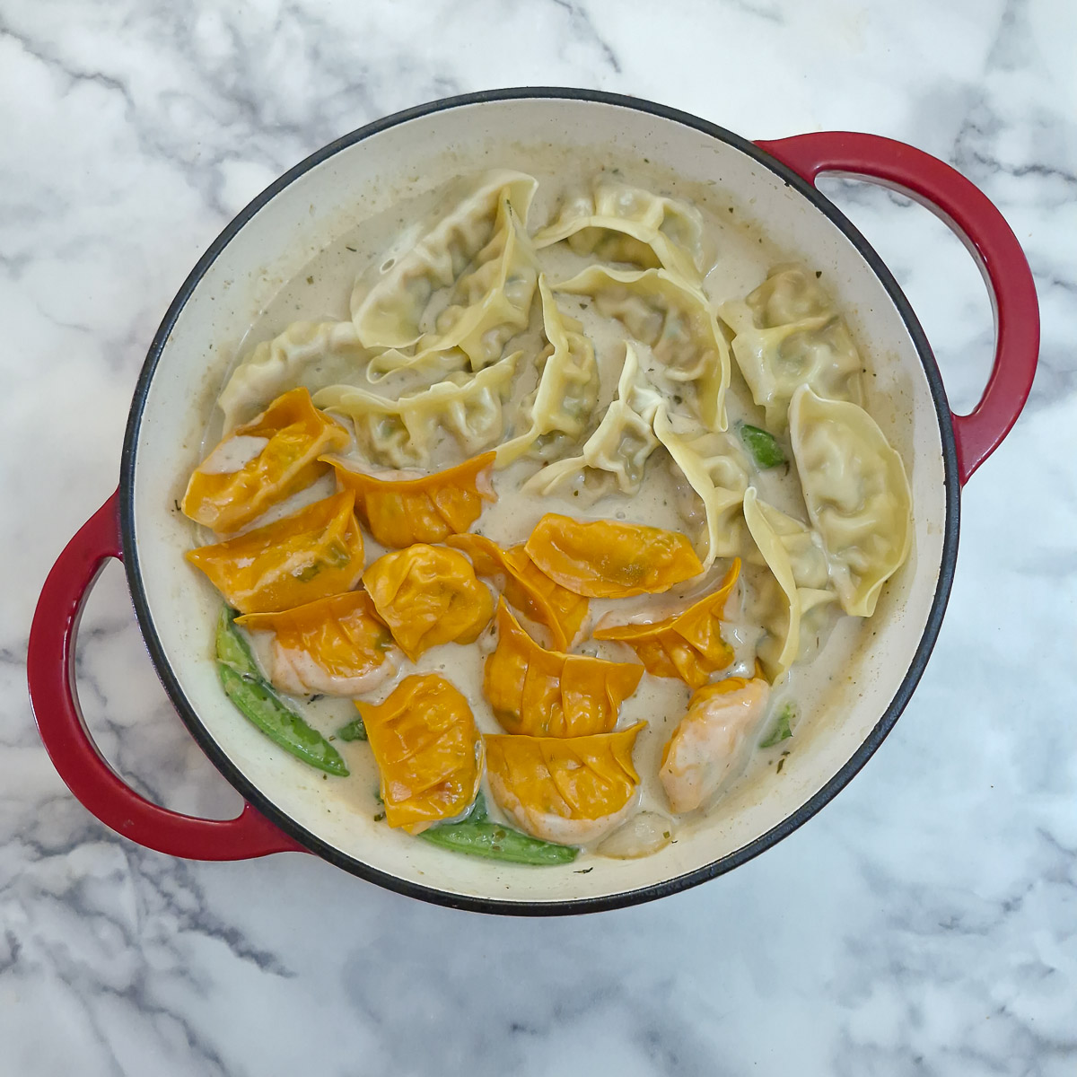 Step 6 - Gyoa nestled between the vegetables in the green curry sauce.