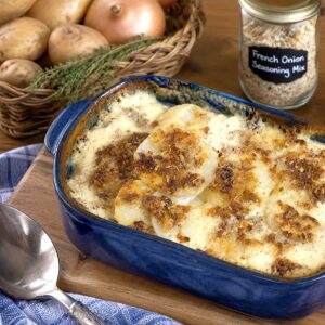 French onion potato bake in a blue baking dish.