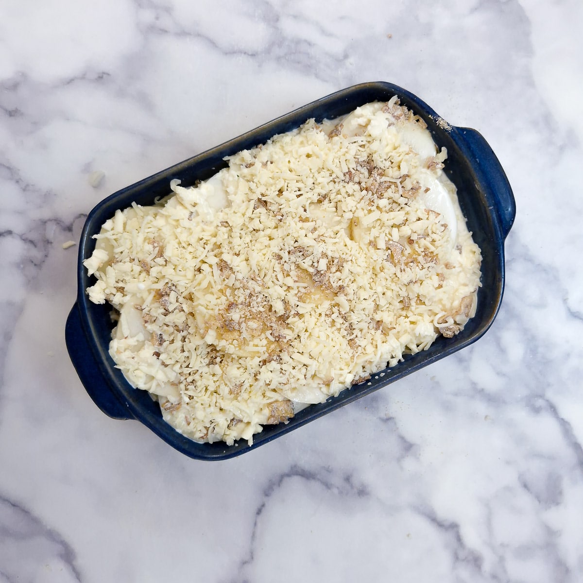 Step 5 - Grated cheese sprinkles over the potatoes.