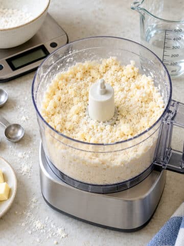 Flour and butter mixed to resemble breadcrumbs in a food processor.