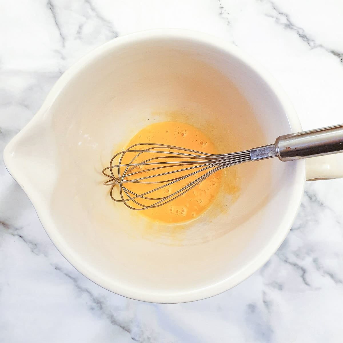 Step 3 - egg yolks being beaten together.