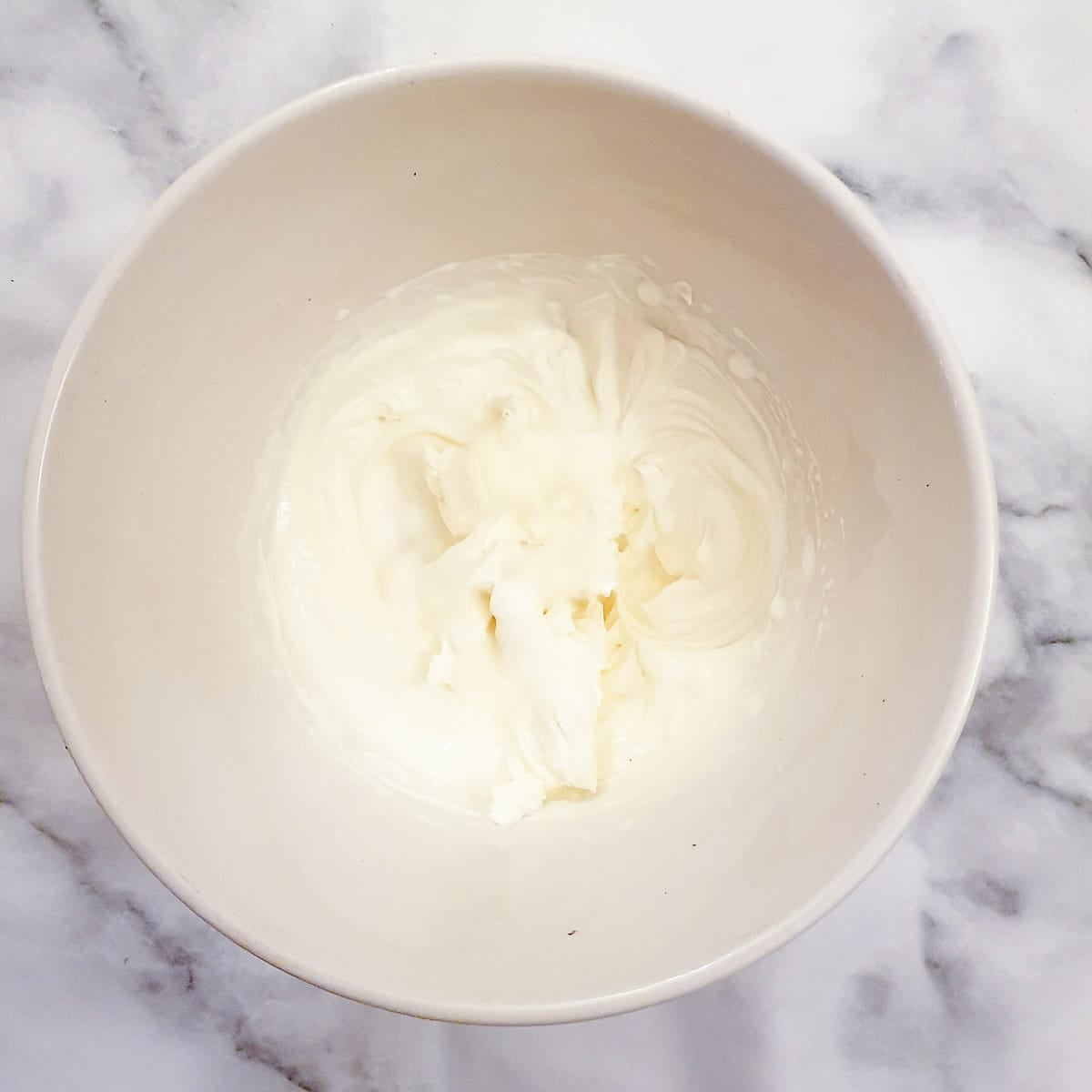 Step 6 - heavy cream whipped to soft peaks in a small white mixing bowl.
