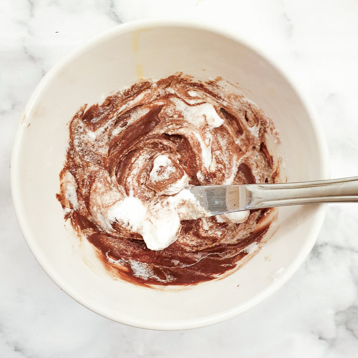 Step 9 - a small amount of beated egg white mixed with the egg, cream and chocolate mixture.