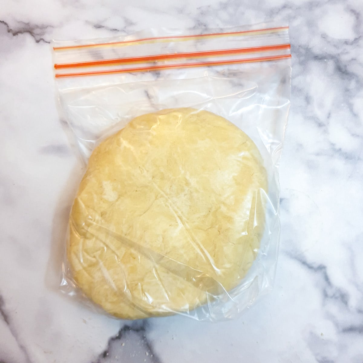 A ball of dough in a plastic bag ready to go into the refrigerator to rest.