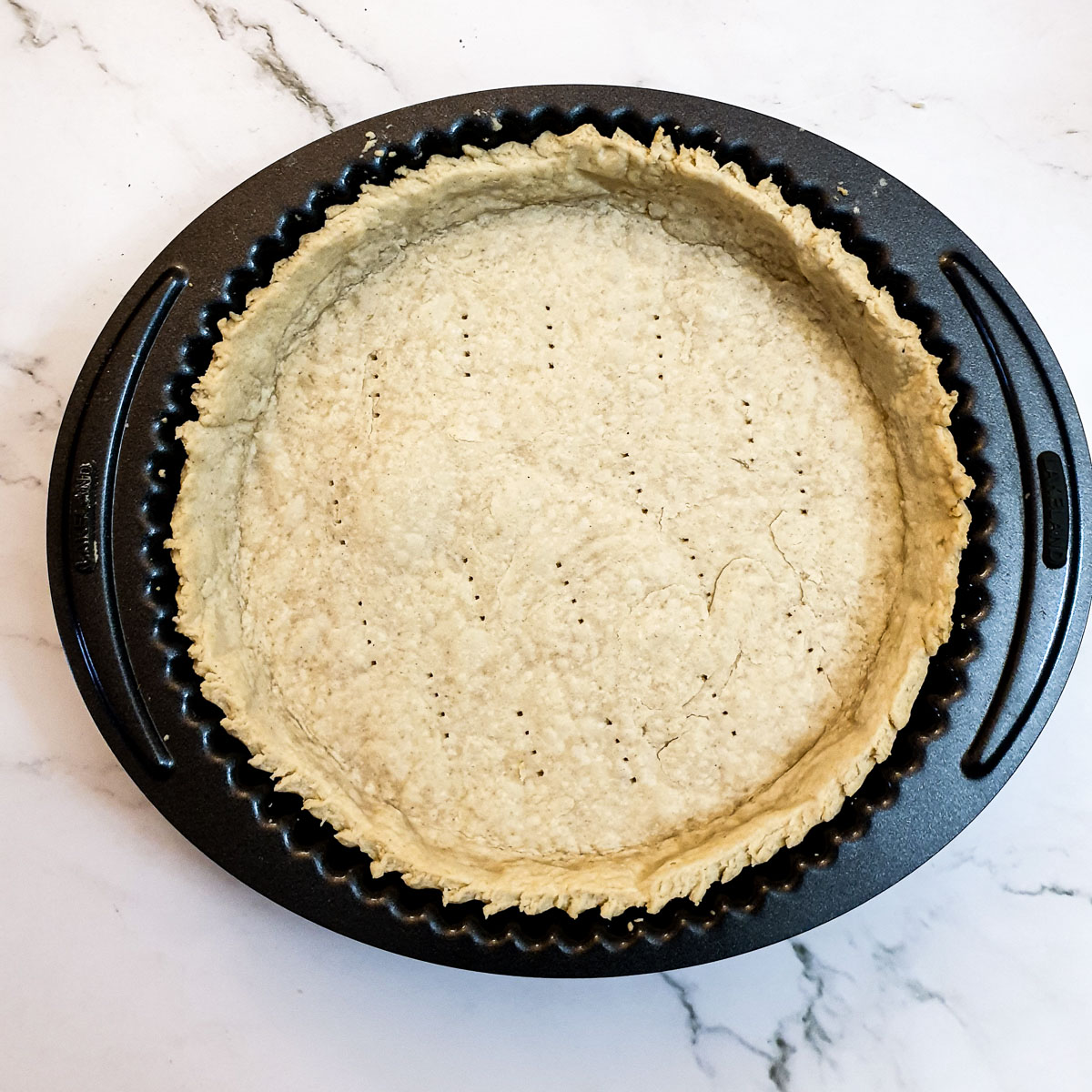 The blind-baked bastry in the flan dish.